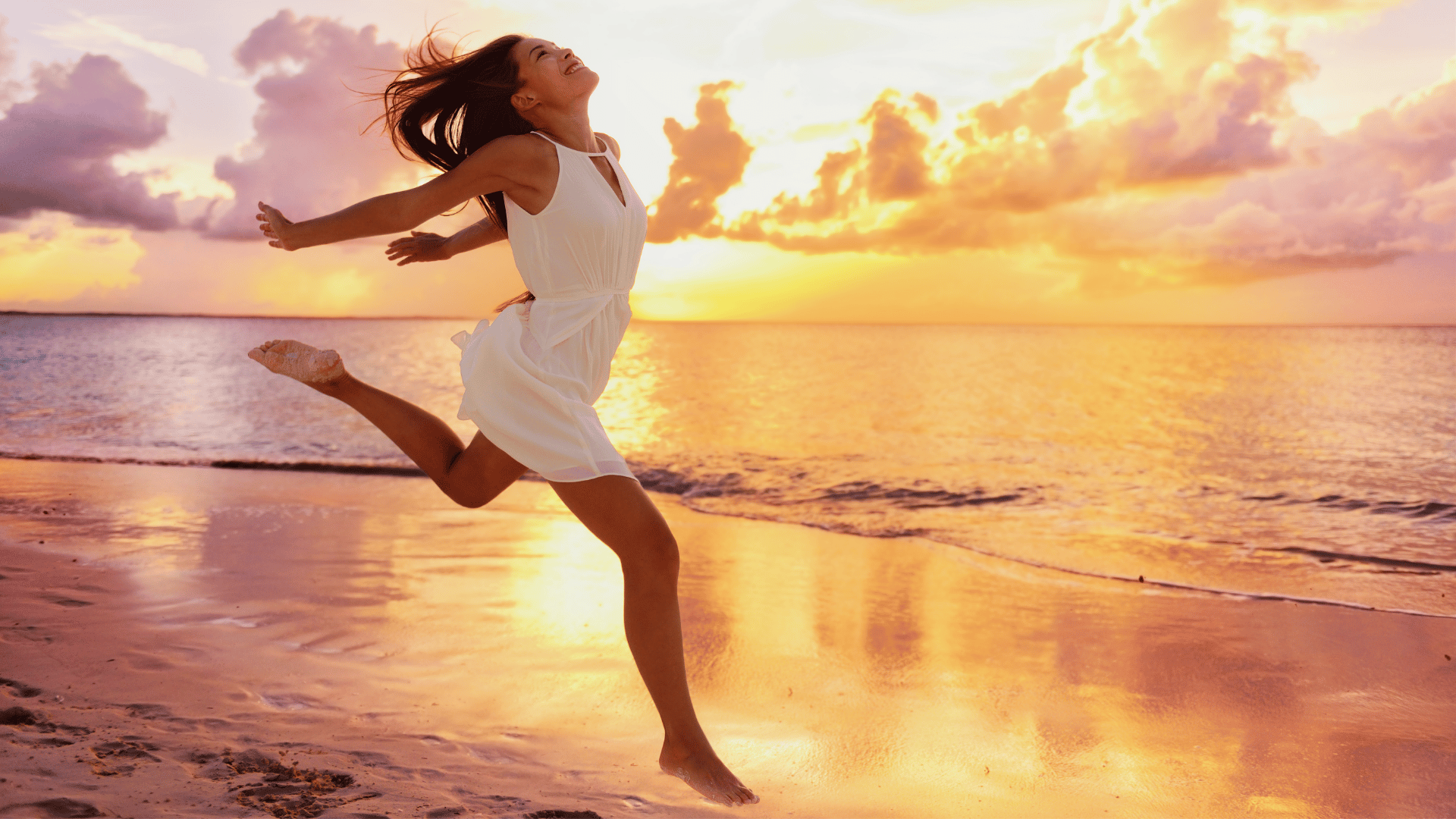 An asian woman is running on a sunlit beach seeking the gift from creating inspirational entrepreneurial confidence by johnsmyk.com